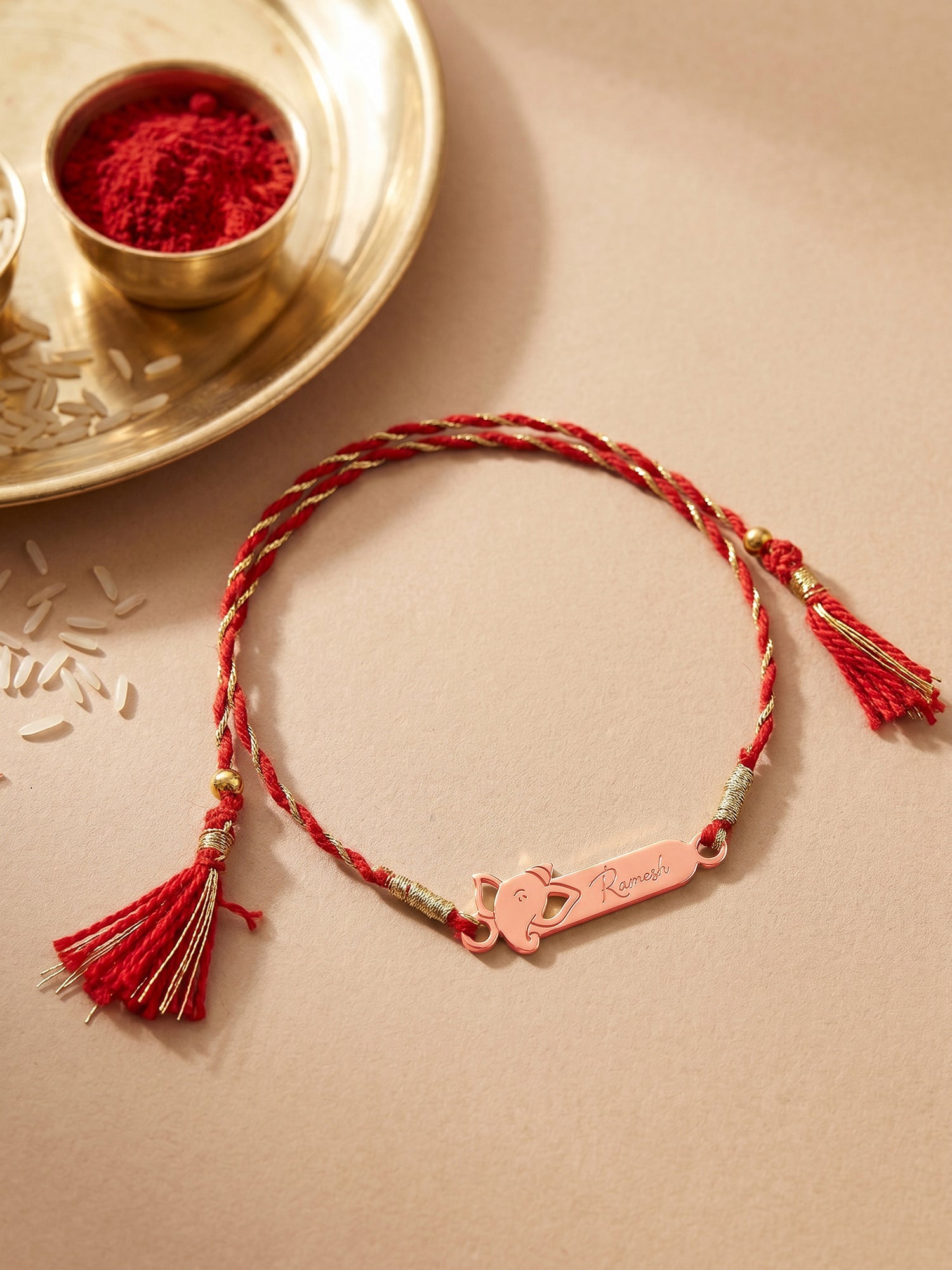 Rose Gold Personalised Sacred Ganesha Rakhi — image 1