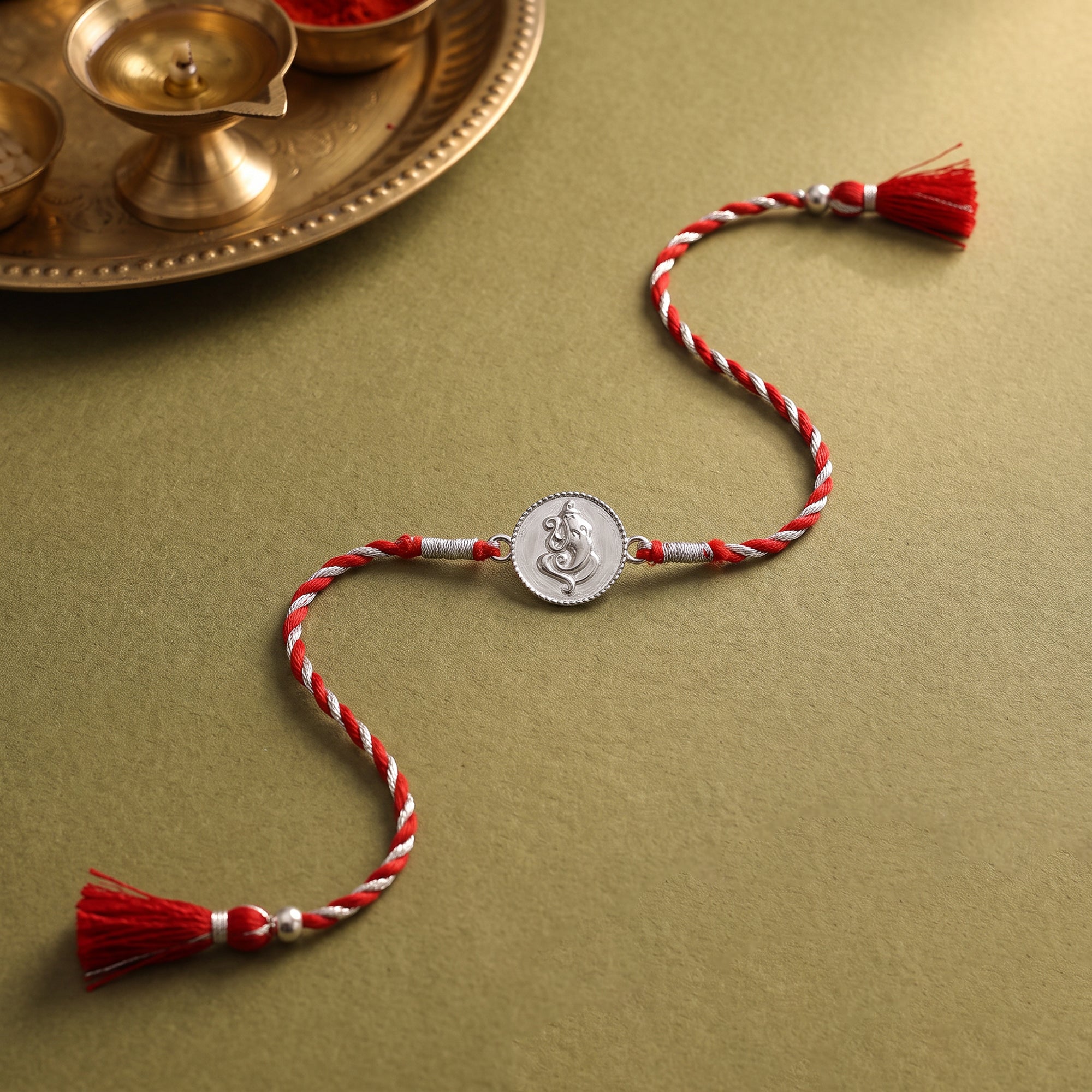 Silver Coin Ganesha Rakhi — image 1