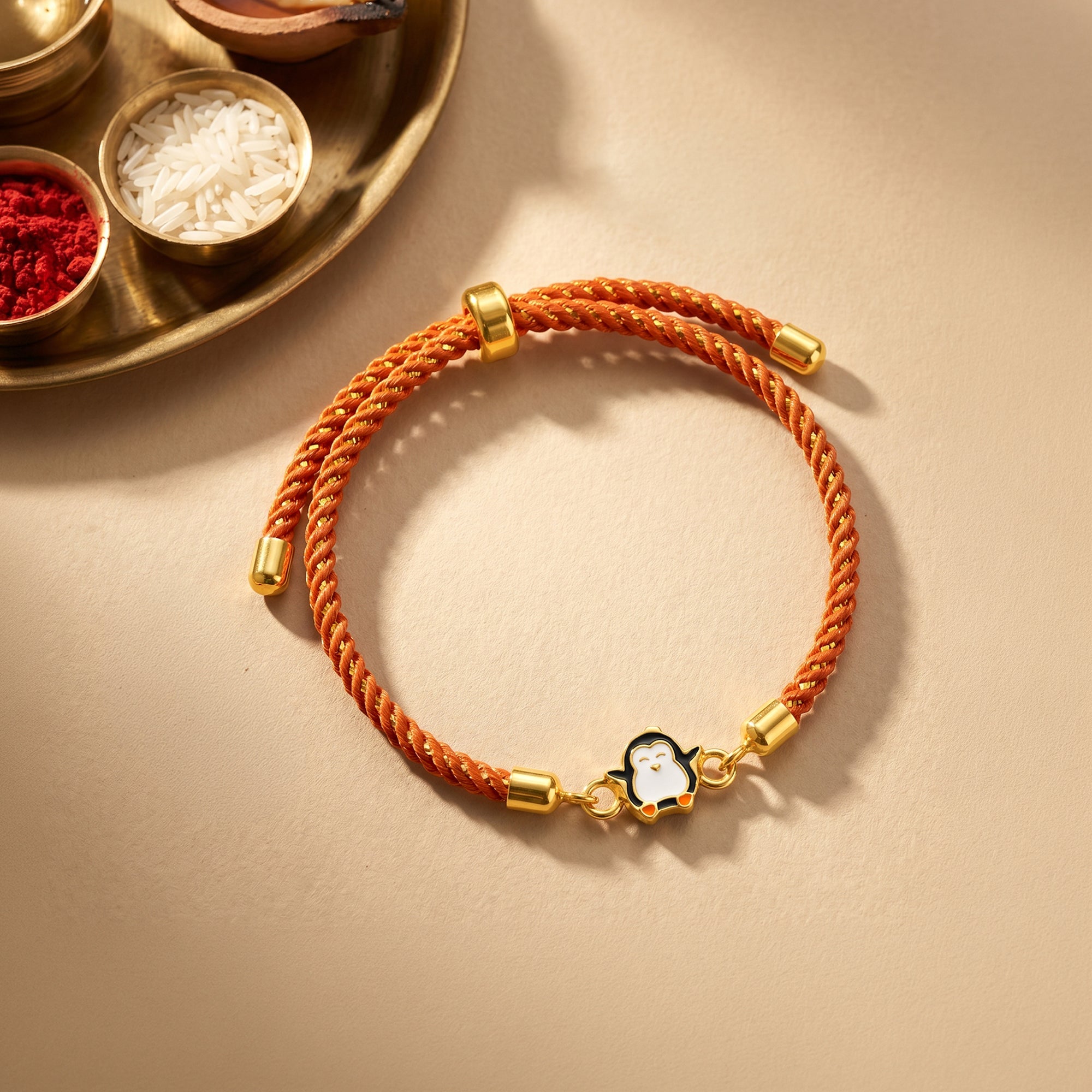 Golden Penguin Joy Rakhi — image 1