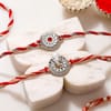 Silver-Plated Ganesh and Floral Rakhi Set of 2